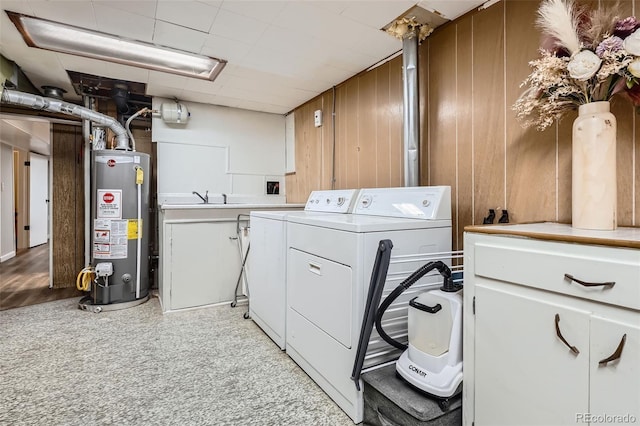 3224 Troy St, Aurora, CO 80011 - washroom with washer and clothes dryer, gas water heater, cabinet space, and light carpet