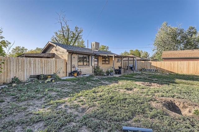3224 Troy St, Aurora, CO 80011 - rear view of property featuring brick siding and a chimney