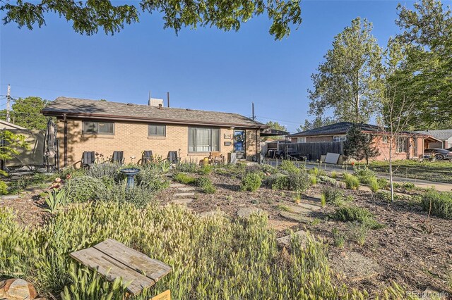 3224 Troy St, Aurora, CO 80011 - rear view of house with brick siding and a patio area