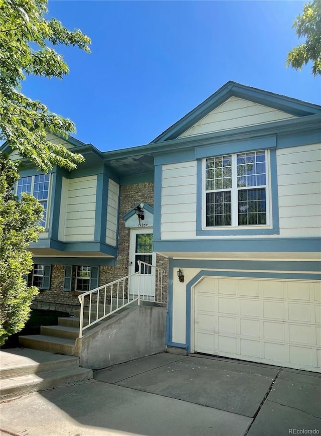 split foyer home with a garage and driveway