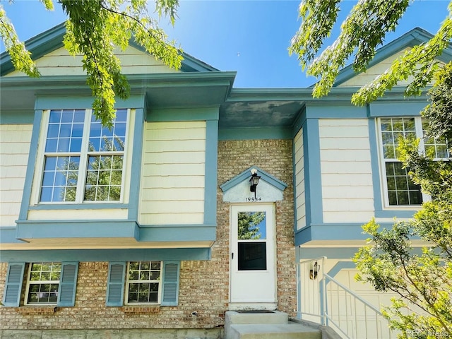 entrance to property featuring an attached garage
