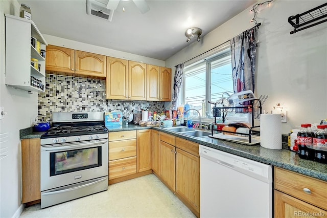 kitchen with white dishwasher, stainless steel range with gas stovetop, sink, ceiling fan, and tasteful backsplash