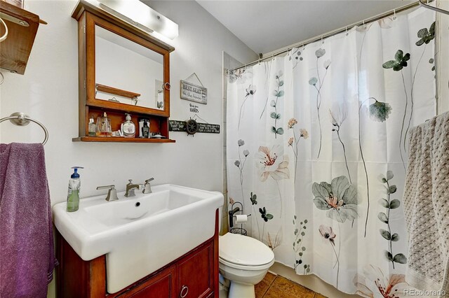 bathroom with tile patterned flooring, vanity, toilet, and a shower with shower curtain