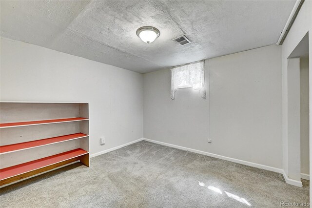 basement with carpet and a textured ceiling