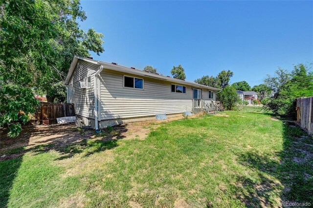 rear view of property with a lawn