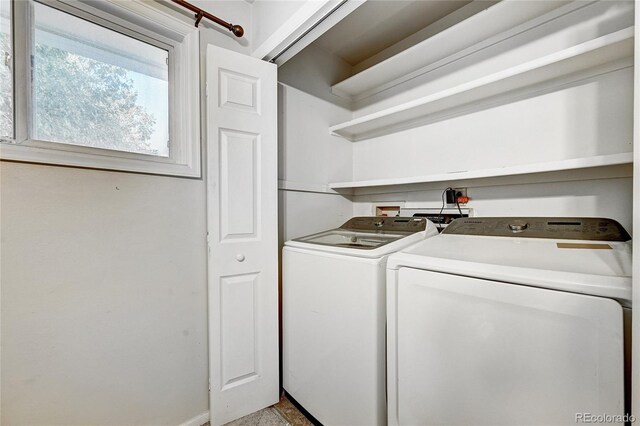 washroom with washing machine and clothes dryer