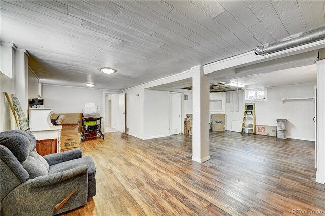 basement with wood ceiling and hardwood / wood-style flooring