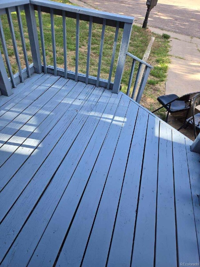 wooden deck featuring a yard