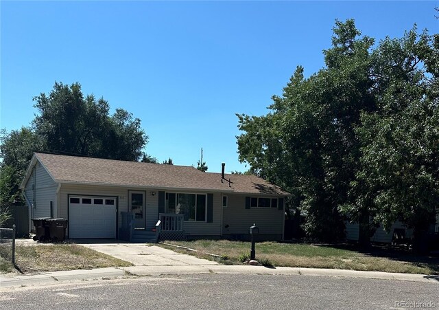 ranch-style home featuring a garage and a front lawn