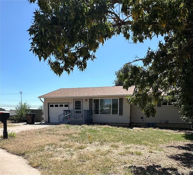 single story home featuring a garage and a front lawn