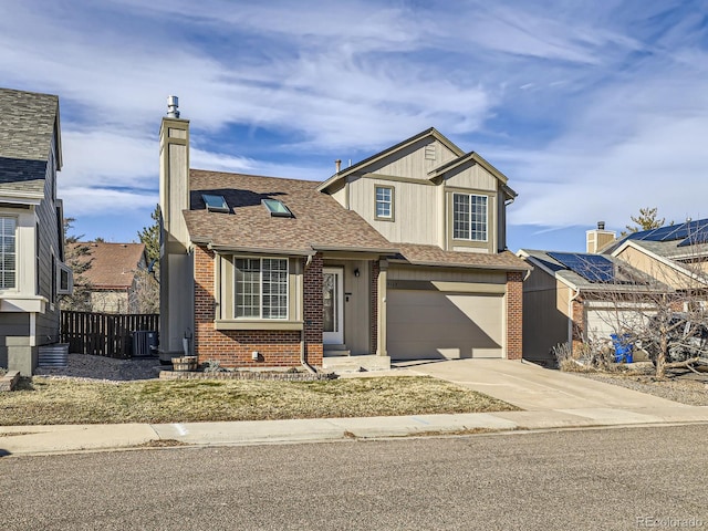 view of front of home featuring central AC unit and a garage