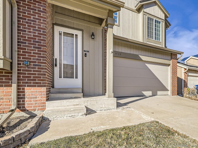 doorway to property with a garage