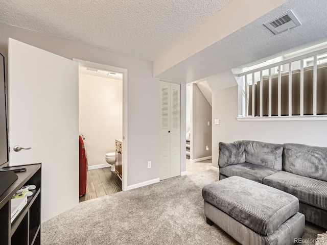 living room featuring carpet flooring and a textured ceiling