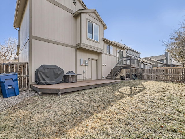 rear view of property featuring a wooden deck