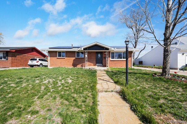 3341 W 94th Ave, Westminster, CO 80031 - view of front of property featuring brick siding, roof mounted solar panels, and a front yard