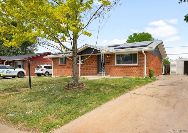 3341 W 94th Ave, Westminster, CO 80031 - view of front facade with brick siding, solar panels, a front yard, and concrete driveway