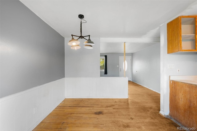 3341 W 94th Ave, Westminster, CO 80031 - empty room with light wood-style flooring, a chandelier, and wainscoting