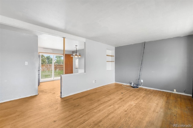 3341 W 94th Ave, Westminster, CO 80031 - unfurnished living room featuring wood finished floors and baseboards