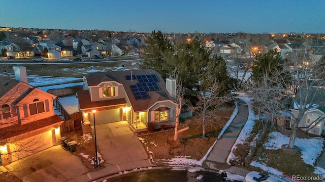 exterior space with a garage and solar panels