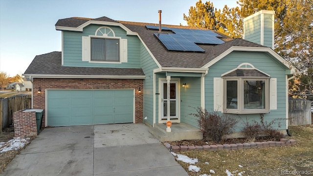 view of front of house featuring a garage and solar panels