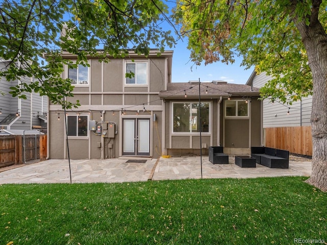 back of property featuring an outdoor hangout area, a yard, a fenced backyard, stucco siding, and a patio area