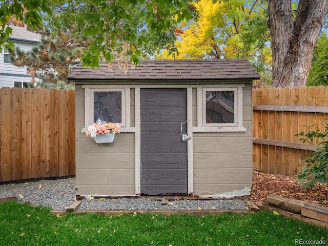 view of shed with fence