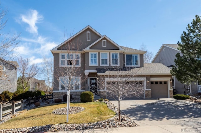 craftsman-style house featuring stucco siding, stone siding, driveway, and fence