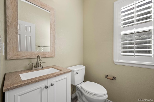 bathroom with toilet and vanity