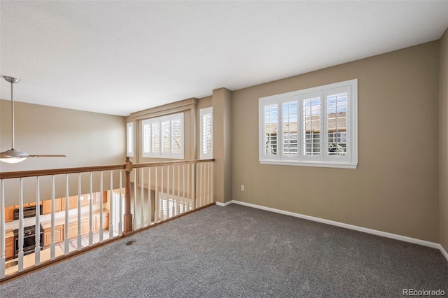 empty room featuring baseboards and carpet floors