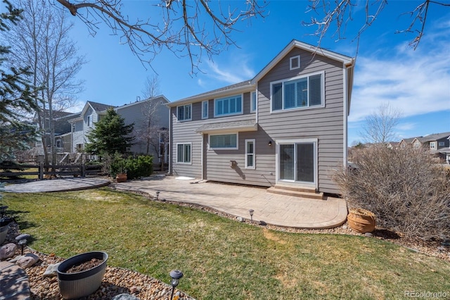 back of house featuring a patio area, a lawn, and fence