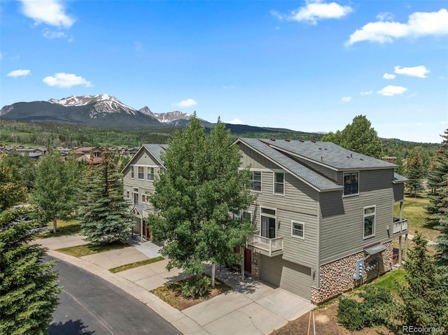 107 Mountain Vista Ln, Silverthorne, CO 80498 - view of front of property featuring concrete driveway, an attached garage, and a mountain view