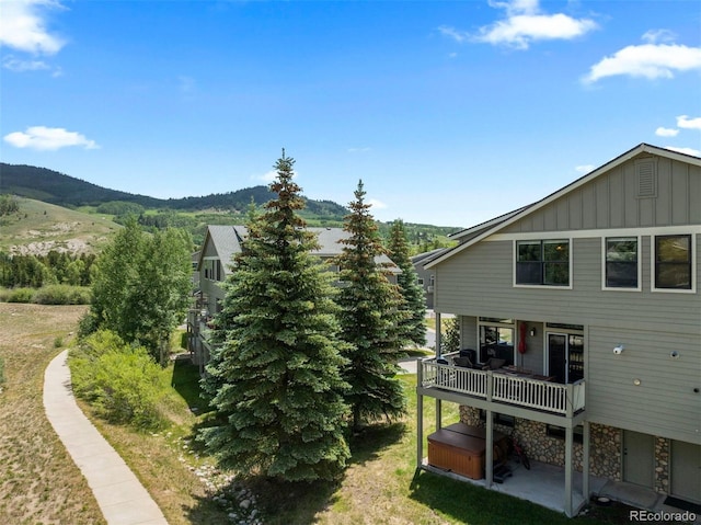 107 Mountain Vista Ln, Silverthorne, CO 80498 - back of property featuring a hot tub, board and batten siding, and a mountain view