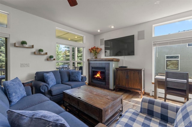 107 Mountain Vista Ln, Silverthorne, CO 80498 - living room featuring a tile fireplace, wood finished floors, plenty of natural light, a ceiling fan, and recessed lighting