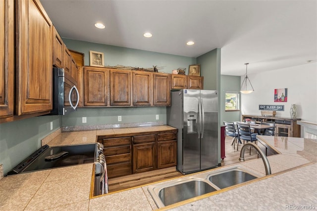 107 Mountain Vista Ln, Silverthorne, CO 80498 - kitchen featuring stainless steel appliances, recessed lighting, pendant lighting, and brown cabinets
