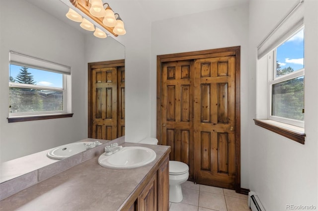 107 Mountain Vista Ln, Silverthorne, CO 80498 - bathroom featuring vanity, tile patterned flooring, plenty of natural light, and a baseboard heating unit