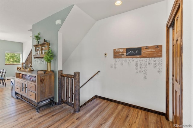 107 Mountain Vista Ln, Silverthorne, CO 80498 - stairway with wood finished floors, recessed lighting, and a baseboard radiator