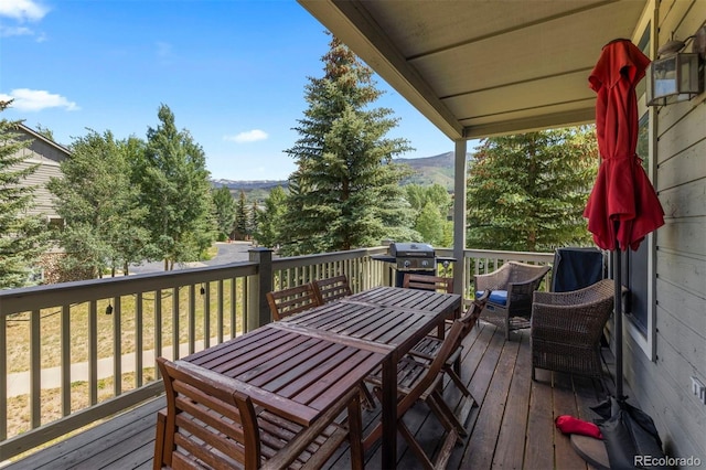 107 Mountain Vista Ln, Silverthorne, CO 80498 - wooden terrace featuring a mountain view, outdoor dining area, and grilling area