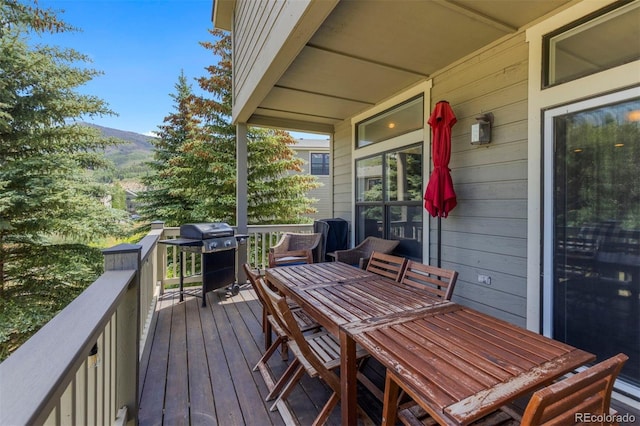 107 Mountain Vista Ln, Silverthorne, CO 80498 - wooden deck with outdoor dining space and grilling area