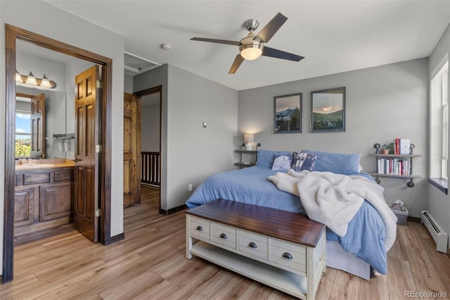107 Mountain Vista Ln, Silverthorne, CO 80498 - bedroom featuring light wood-style floors, a baseboard radiator, connected bathroom, and a ceiling fan