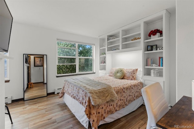 107 Mountain Vista Ln, Silverthorne, CO 80498 - bedroom with a baseboard radiator, baseboard heating, and light wood-type flooring
