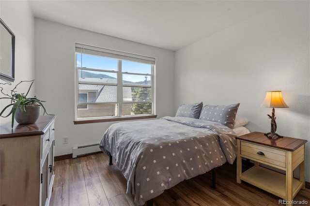 107 Mountain Vista Ln, Silverthorne, CO 80498 - bedroom featuring a baseboard heating unit and wood finished floors