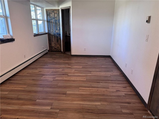 107 Mountain Vista Ln, Silverthorne, CO 80498 - empty room with wood finished floors and a baseboard heating unit