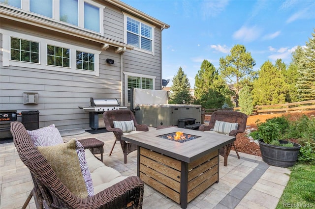 view of patio with a hot tub, an outdoor living space with a fire pit, and grilling area