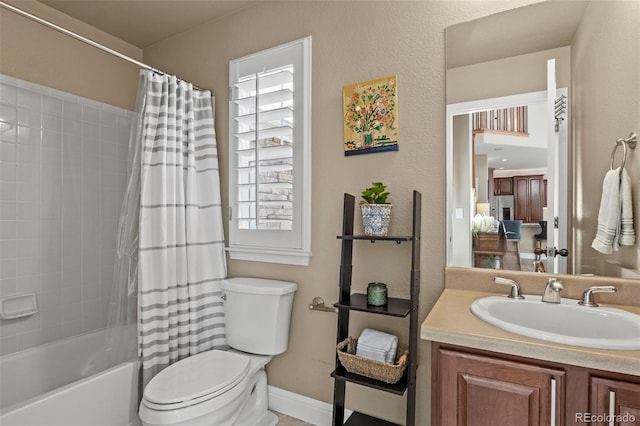 full bathroom featuring vanity, shower / bathtub combination with curtain, and toilet