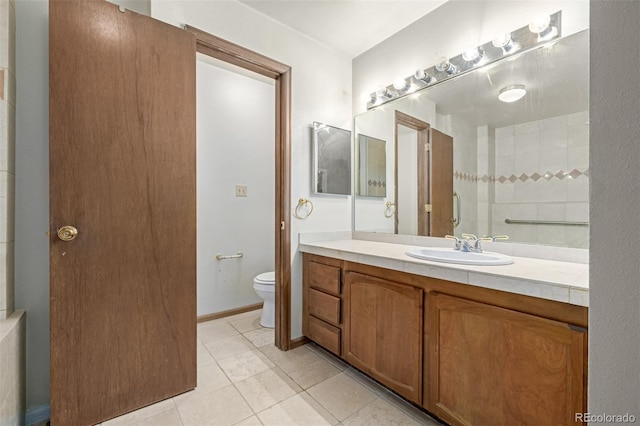 bathroom featuring vanity, tile patterned floors, and toilet