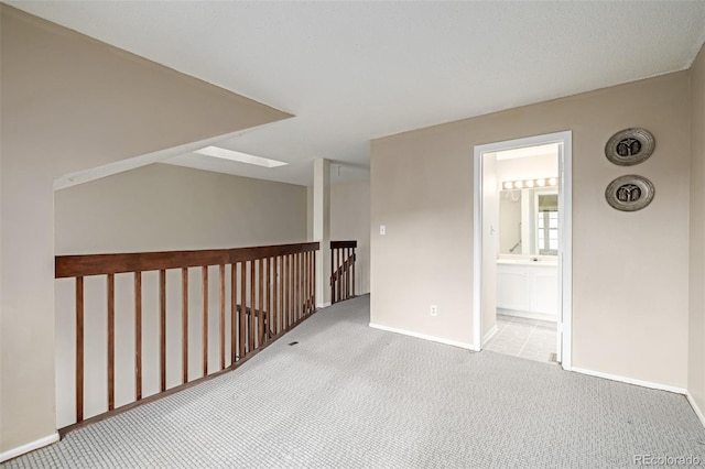 unfurnished room with light colored carpet