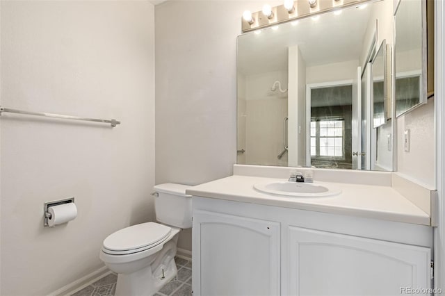 bathroom with vanity, tile patterned flooring, and toilet