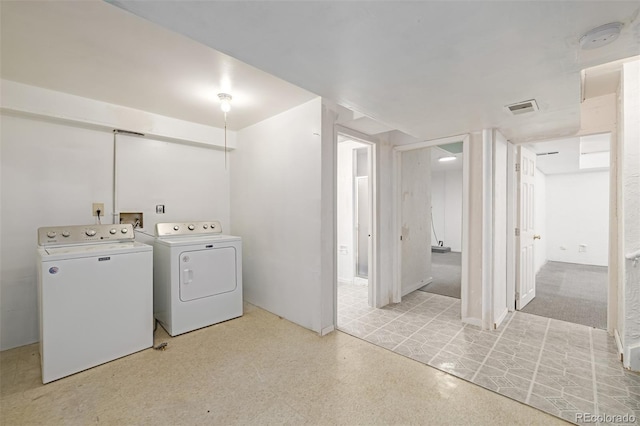 laundry area with washing machine and clothes dryer