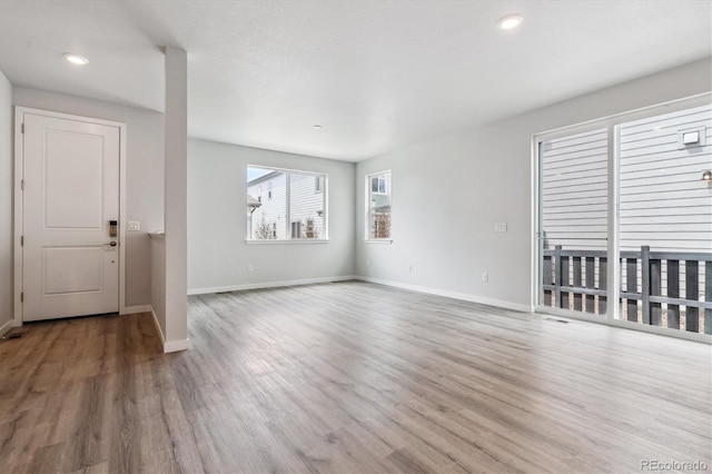 14149 Deertrack Ln, Parker, CO 80134 - unfurnished living room featuring wood finished floors, baseboards, and recessed lighting
