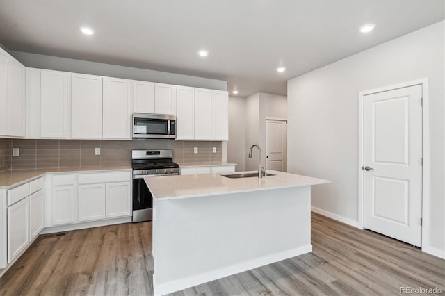 14149 Deertrack Ln, Parker, CO 80134 - kitchen with appliances with stainless steel finishes, a sink, light wood finished floors, light countertops, and recessed lighting